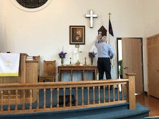 Preacher inside a church, back turned